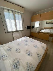 a bedroom with a large bed with blue flowers on it at Casa Angelina -Humanitas- Forum Assago in Rozzano +10 photos
