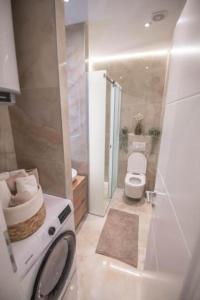 a bathroom with a toilet and a shower and a sink at Canta Amore Suites in Zadar +34 photos