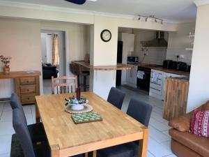 a dining room and kitchen with a wooden table and chairs at 3 bed semi detached house near Stourbridge in Stourbridge