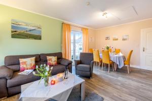 a living room with a couch and a table at Ferienhaus Rose in Fehmarn