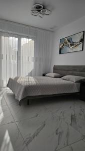 a bedroom with a bed and a ceiling fan at Luxury Beachfront Family Apartment in La Pineda +49 photos