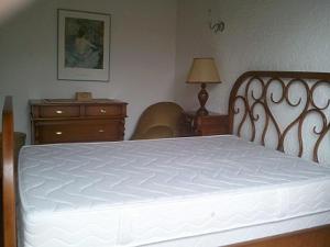 En eller flere senge i et værelse på Capriga
