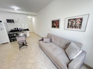 a living room with a couch and a chair at LK Centro 6 in Belo Horizonte