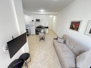 a living room with a couch and a kitchen at LK Centro 6 in Belo Horizonte