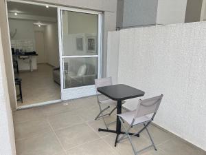 a table and two chairs sitting in a room with a table and chairsktop at LK Centro 6 in Belo Horizonte +46 photos