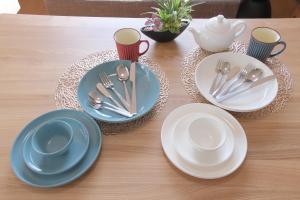 a table with blue and white plates and cups and spoons at Villa Lotus in Kamakura