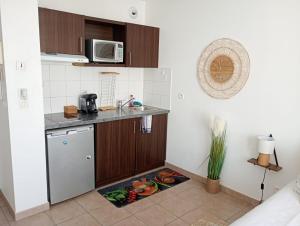 a kitchen with a sink and a counter with a plate of food at B301 Disney Paris AppartementAppartement in Montévrain