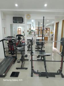 a gym with a row of treadmills and machines at ESPERANZA Pension House & Restaurant in Roxas +56 photos