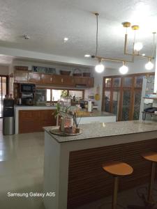 a kitchen with a counter and two bar stools at ESPERANZA Pension House & Restaurant in Roxas