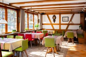 a restaurant with tables and chairs and windows at Gasthof Lamm GARNI in Sulz am Neckar