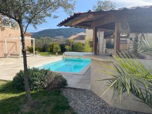 a swimming pool in a yard with a house at Maison à Sablet in Sablet
