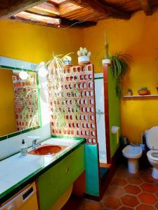 a colorful bathroom with a sink and a toilet at Cortijo Rural Finca HUERTA SANTA MARÍA in Galaroza +10 photos