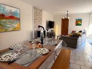 a living room with a table with wine glasses at La Solognote-Châteaux & Beauval in Contres