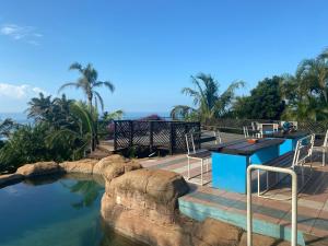 a pool with a table and chairs next to the water at BlueSkyMining in Kingsborough