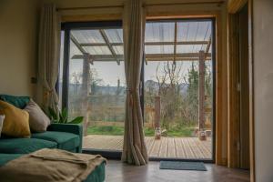 a living room with a large sliding glass door at Cuilcagh Cabins in Letterbreen
