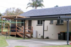 a house being constructed with a porch and a deck at Leo's Beach Haven in Batehaven