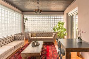 a living room with a couch and a table at Avgerinos in Makrochórion