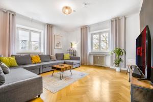 a living room with a couch and a tv at Apart21- Spacious 3 BR with WiFi Kitchen Games in Ingolstadt