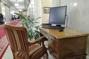 a desk with a laptop computer and a chair at Legendary Hotel Sovietsky in Moscow