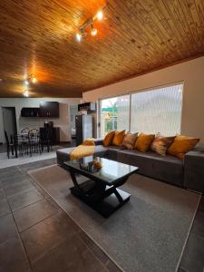 a living room with a couch and a table at 15 On Palm East in Edenvale