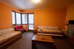 a living room with two beds and a table at ChataKováčová in Kováčová +104 photos