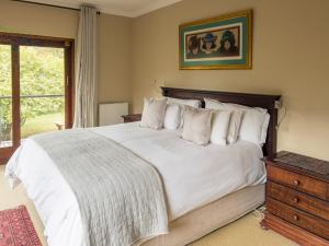 a bedroom with a large bed with white sheets and pillows at 727 Church in Clarens