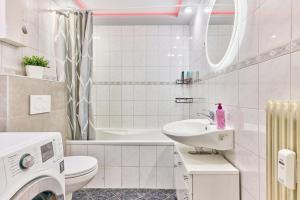 a white bathroom with a sink and a toilet at Ida, the suburban apartment nearby Cologne in Bergheim +18 photos