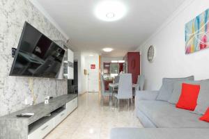 a living room with a couch and a flat screen tv at Beproud Gc in Maspalomas