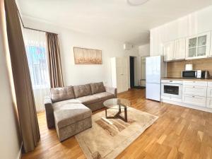 a living room with a couch and a table at Luxury Central Apartment Easy Kaunas in Kaunas