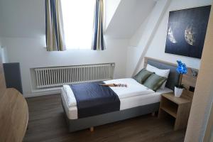 Postel nebo postele na pokoji v ubytování Centra Hotel Winterthur