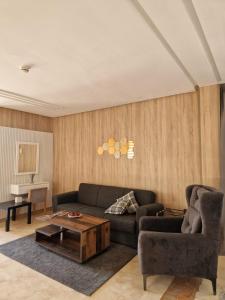 a living room with a couch and a coffee table at Palm Palace Bouznika in Bouznika