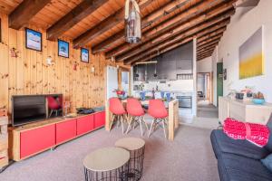 a living room with red chairs and a kitchen at Mayens de l Ours CZ 030 - MOUNTAIN apartment 6 per in Agettes