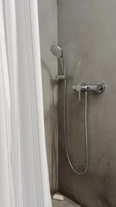 a shower with a shower head in a bathroom at Eros Home Serifos in Serifos Chora