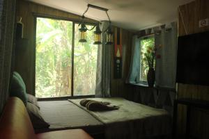 a dog laying on a bed in a room with a window at Do Dee cafe in Bangkok +146 photos