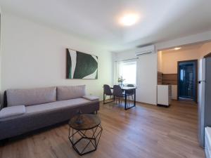 a living room with a couch and a table at Cozy apartment with breakfast on request 1 in Pula