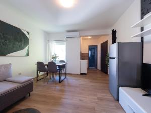 a living room with a couch and a table at Cozy apartment with breakfast on request 1 in Pula