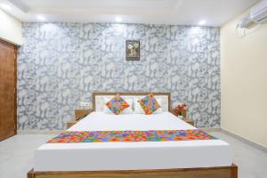 a bedroom with a bed and a blue and white wall at Aditya Guest House in Varanasi +11 photos