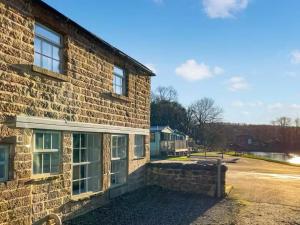 a brick building with windows on the side of it at Riverview Cottage at Lido Leisure Park in Knaresborough