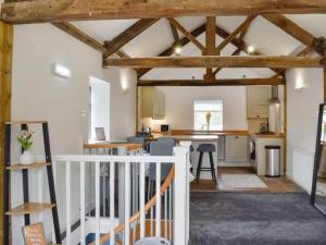 an open kitchen and living room with wooden beams at Riverview Cottage at Lido Leisure Park in Knaresborough