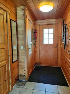 a hallway of a cabin with a door and a window at Loma-Otso A in Kalajoki