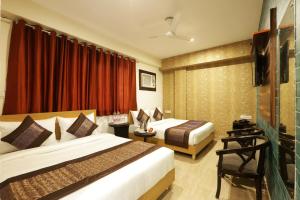 Postel nebo postele na pokoji v ubytování Hotel Airport Paradise At Delhi Airport