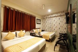 Postel nebo postele na pokoji v ubytování Hotel Airport Paradise At Delhi Airport
