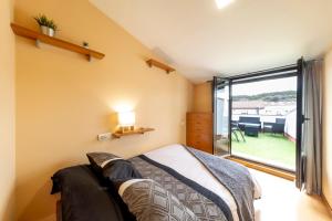 Ένα ή περισσότερα κρεβάτια σε δωμάτιο στο Ático Duplex CALLE MAYOR +43 φωτογραφίες