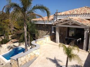 a villa with a swimming pool and a house at Villa Antonella in Villasimius