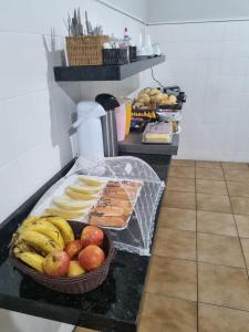 a table with a basket of fruit on a counter at Avenida Hotel in Presidente Prudente +20 photos