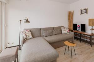 a living room with a couch and a table at Sarant 0202 in Koksijde