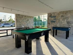 a room with two ping pong tables in it at Malia Beach Muro Alto 300 Metros Do Mar in Porto De Galinhas