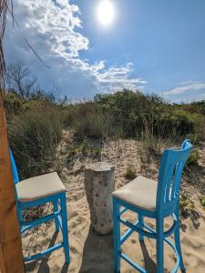 two chairs and a stool on the beach at Каравана The Jungle in Chernomorets +3 photos