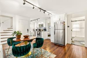 a kitchen with a table and chairs and a refrigerator at Federal Hill PRIDE in Providence