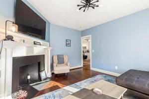a living room with a couch and a fireplace at Federal Hill PRIDE in Providence